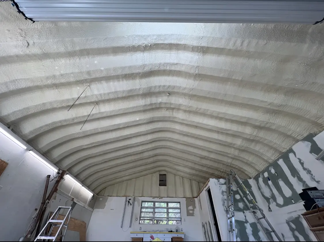 Spray polyurethane foam applied to the underside of a metal roof deck in Mustang